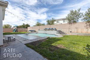 View of pool featuring an outdoor living space, a patio area, a playground, and a yard