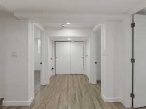 Hall featuring light hardwood / wood-style flooring