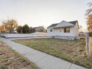 Exterior space featuring a front yard and a porch