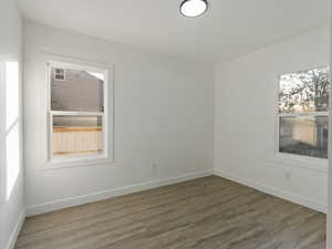 Unfurnished room featuring dark wood-type flooring