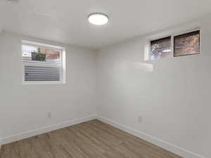 Spare room with hardwood / wood-style floors and a textured ceiling