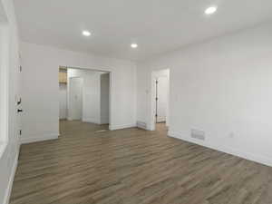 Empty room with dark hardwood / wood-style flooring