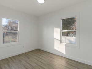 Spare room with hardwood / wood-style flooring and a wealth of natural light