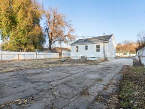 Rear view of property featuring central AC unit