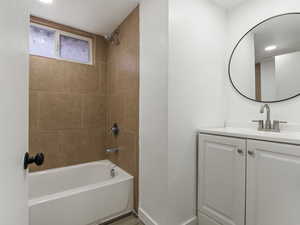 Bathroom featuring vanity and tiled shower / bath