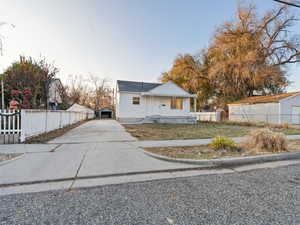 View of front of house with a garage and an outdoor structure