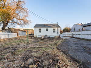 Rear view of property with cooling unit