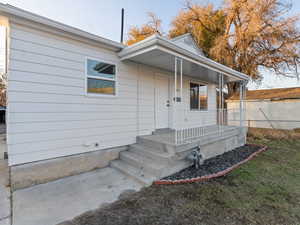 Doorway to property with covered porch