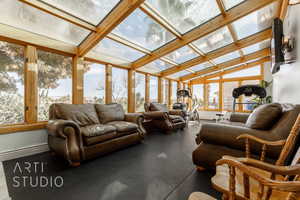 Sunroom featuring a healthy amount of sunlight and vaulted ceiling