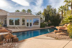 View of swimming pool with french doors