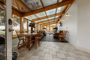 Sunroom / solarium with a wealth of natural light and lofted ceiling