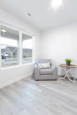 Living area with light wood-type flooring