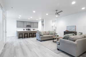 Living room featuring light hardwood / wood-style flooring and ceiling fan