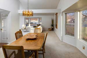 Dining area with plenty of natural light and vaulted ceiling