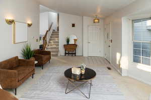 Carpeted entryway featuring an inviting chandelier and vaulted ceiling