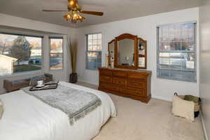 Carpeted bedroom with ceiling fan