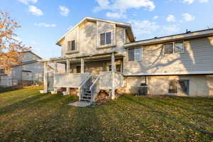 Rear view of property with a pergola, a yard, central AC unit, and a deck