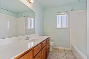 Full bathroom featuring tile patterned flooring, vanity, bathtub / shower combination, and toilet