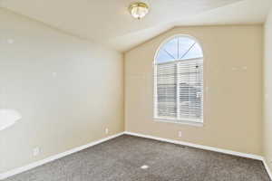 Bedroom with carpet and vaulted ceiling