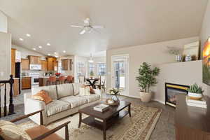 *Virtually Staged* Carpeted living room featuring ceiling fan and vaulted ceiling