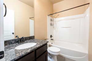 Full bathroom with shower / tub combination, vanity, and toilet