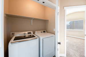 Laundry area featuring carpet and independent washer and dryer