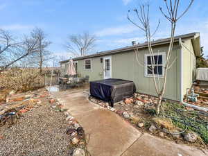 Rear view of house featuring a patio