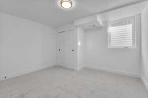 Unfurnished room with light carpet and a textured ceiling