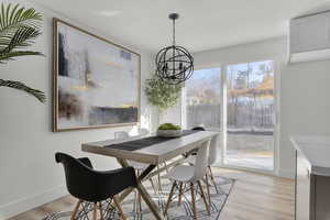 Dining space featuring light hardwood / wood-style flooring and an inviting chandelier