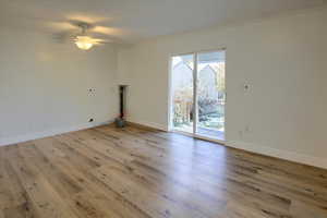 Spare room with ceiling fan, ornamental molding, and light wood-type flooring