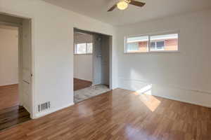 Unfurnished room with hardwood / wood-style floors and ceiling fan