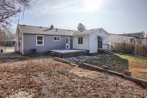 Back of house featuring central AC unit