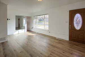 Foyer entrance featuring light hardwood / wood-style floors