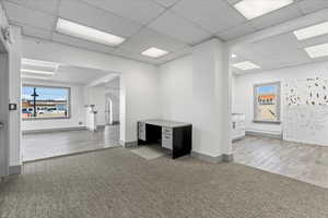 Spare room featuring hardwood / wood-style flooring and a drop ceiling