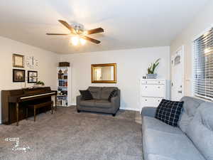 Living room with carpet and ceiling fan