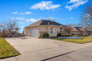 View of front of house featuring a garage and a front lawn