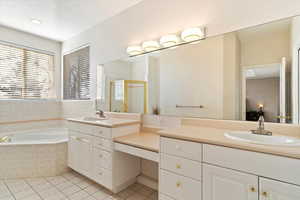 Bathroom with tile patterned flooring, vanity, and independent shower and bath