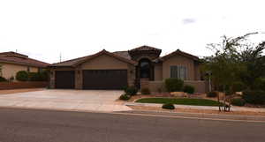 Mediterranean / spanish home featuring a garage