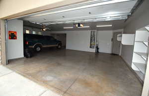 Garage featuring water heater and a garage door opener