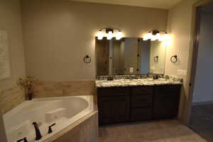 Bathroom with vanity and a relaxing tiled tub