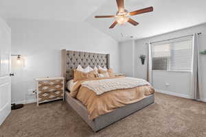 Bedroom featuring carpet, vaulted ceiling, and ceiling fan