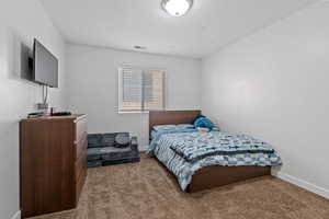 Bedroom featuring light colored carpet