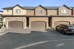 Townhome / multi-family property featuring a garage