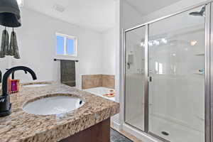 Bathroom with vanity and separate shower and tub