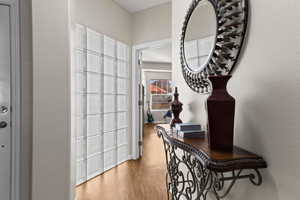 Hallway with hardwood / wood-style flooring