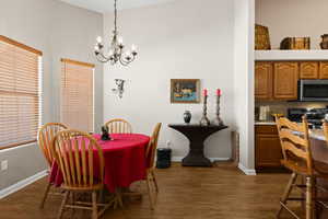 Dining room with a chandelier and dark hardwood / wood-style flooring