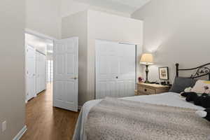 Bedroom featuring a closet and dark wood-type flooring