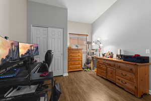 Office space featuring hardwood / wood-style floors and vaulted ceiling