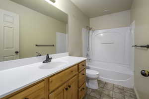 Full bathroom featuring shower / bathing tub combination, vanity, and toilet