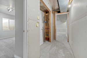 Hallway with light colored carpet